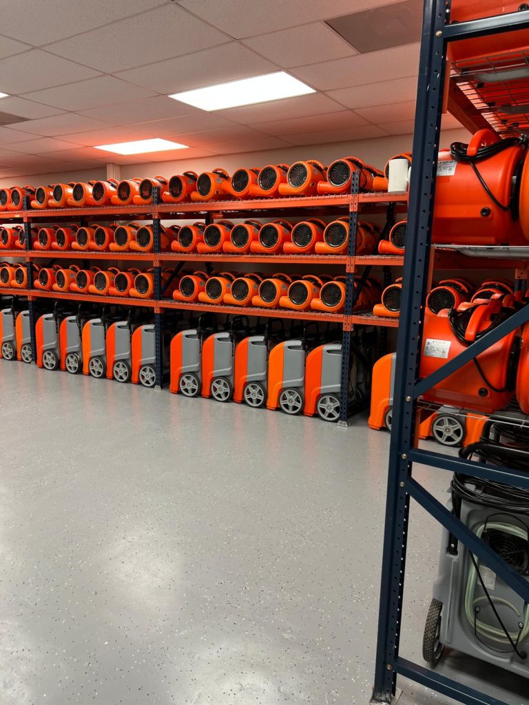 Restoration 24 Storage room with industrial air movers and dehumidifiers for restoration.